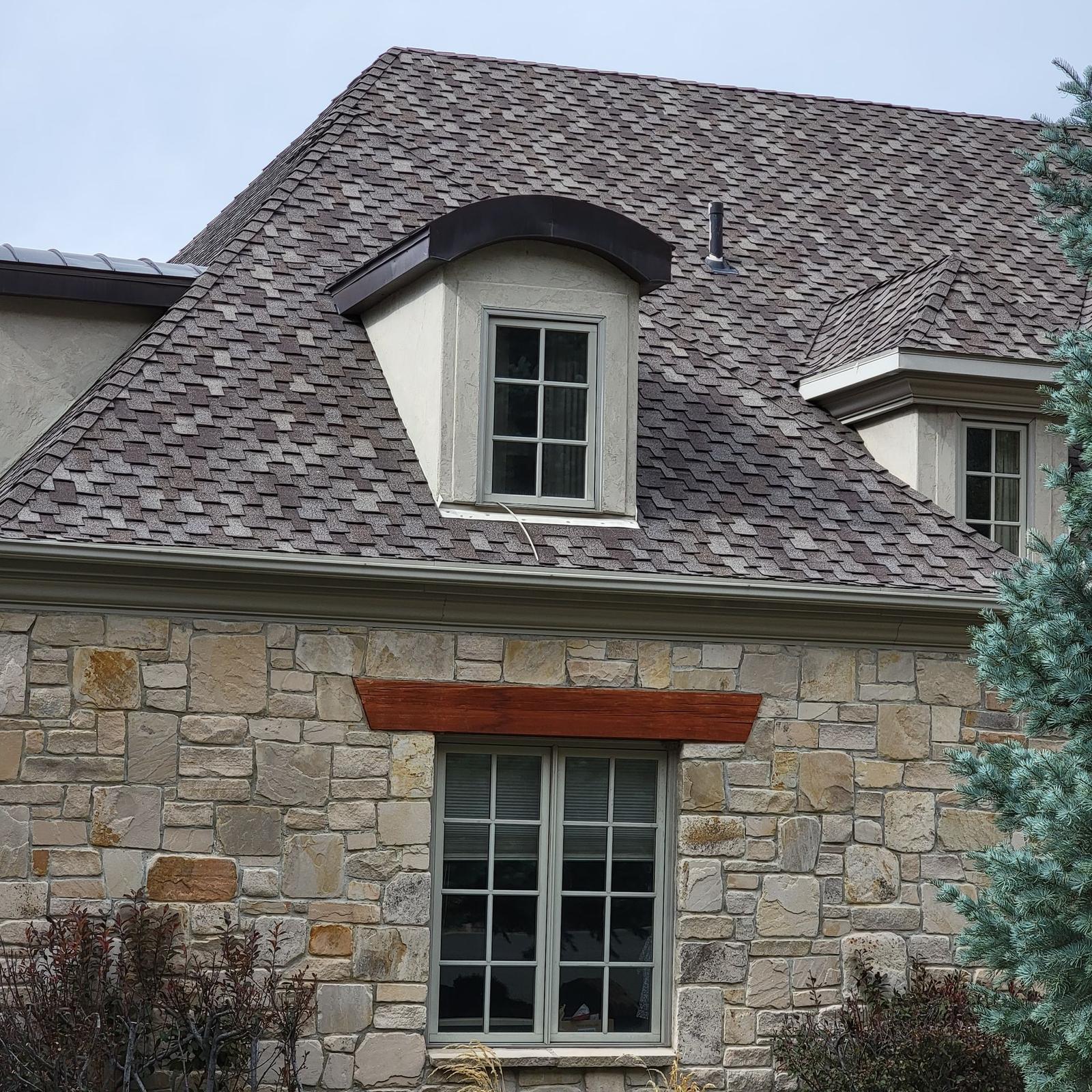 Stone home with new roof and dormers in Salt Lake City