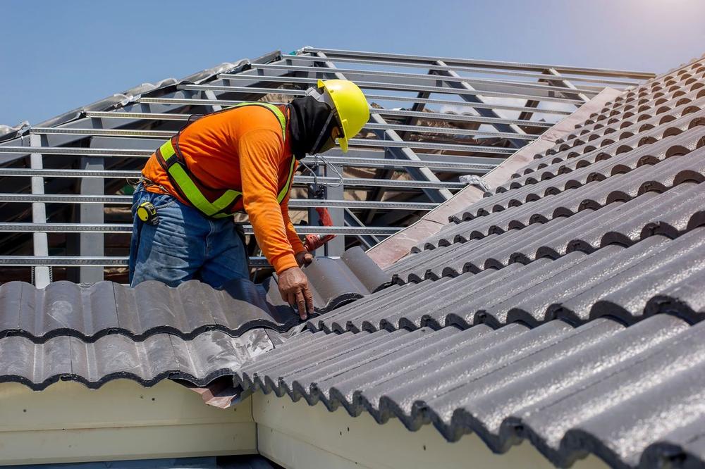 Roofer installing tile roofing